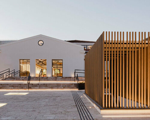 flexible wooden modules attach to revitalized market's original metal trusses in spain