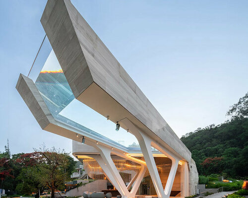 cantilevered transparent pool hovers above hotel complex in thailand