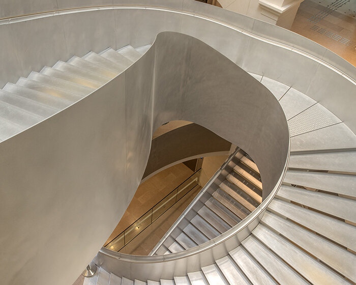 monumental staircase meanders within national library of france, captured by danica o. kus