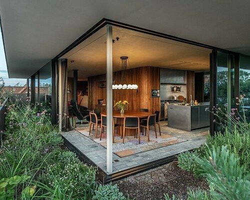 rounded volume made of walnut wood lies in the heart of penthouse T by objekt architecten