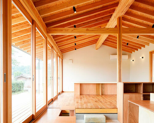 wooden coffee shop in japan sets up multileveled interiors under an eave roof