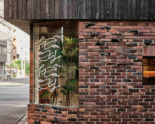 renovated restaurant by stod preserves its historic brick frame in japan