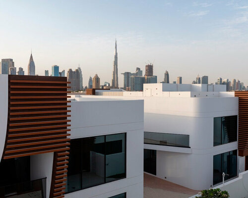 twenty-eight curved townhouses compose the fold residential complex in dubai