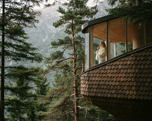 new woodnest treehouses are suspended among pine forests of odda, norway