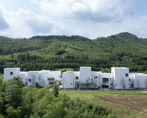 jumping house lab designs rural hotel as an array of interwoven white volumes