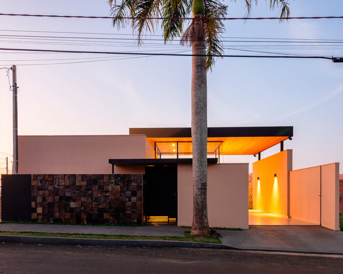 wood-clad cantilevers appear hovering above ser arquitetos' glass house in brazil