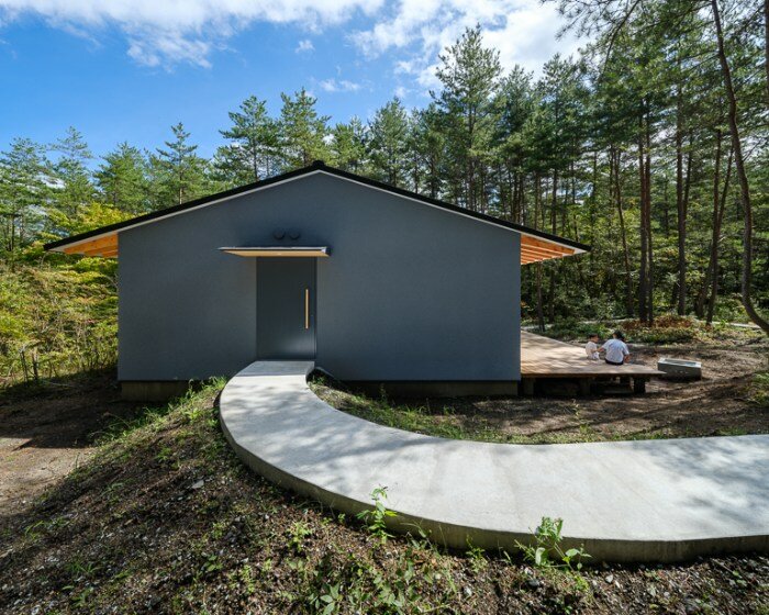 a light and nature infused corridor punctuates YSLA architects' idyllic forest retreat in japan