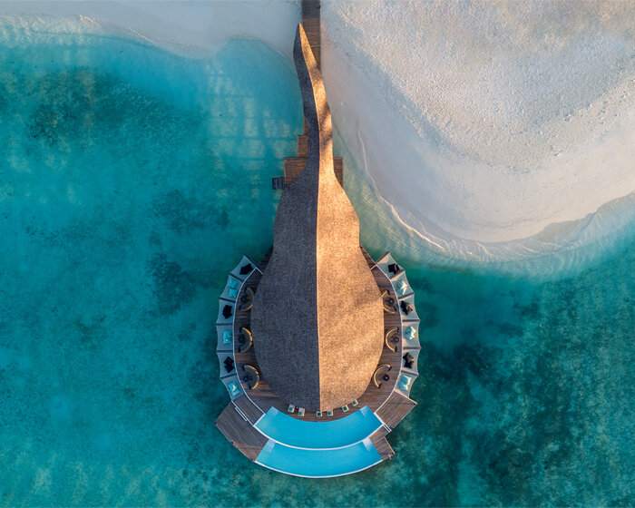 atelier nomadic's overwater bamboo restaurant emerges like a sea creature in the maldives