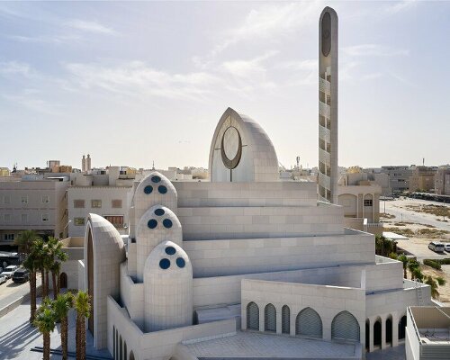 rhythmically stacked, rotating volumes and half domes compose kuwaiti mosque