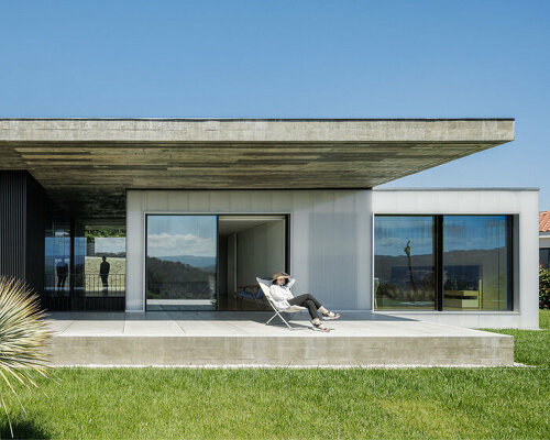 stu.dere shapes its 'casa ponte' as a concrete slab atop glowing boxes in portugal