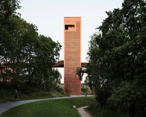 MONO architekten builds a tower of red-tinted rammed earth in germany