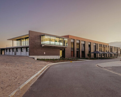 permeable brown brick facade enfolds wastewater control center in cape town