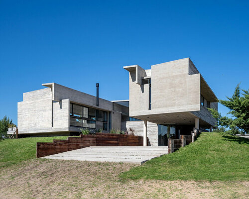 two elevated rectangular concrete prisms shape residence on the buenos aires coast