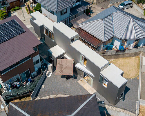 elongated house KJ lies on narrow flagpole lot between residences in japan