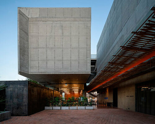 porous expanded-metal mesh skin adorns art center's concrete facade in bangkok