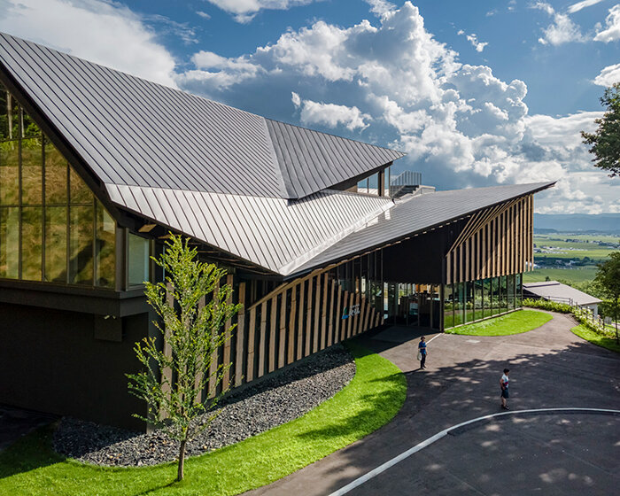 kengo kuma cloaks hot spring resort in hokkaido with locally sourced larch wood