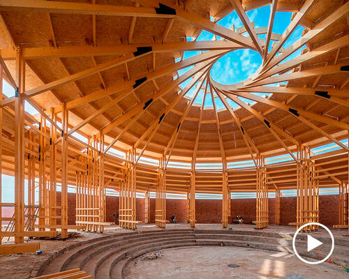 LUO studio tops exhibition hall in china with spiral wooden roof frame