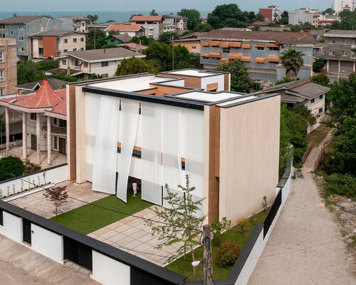 long white curtains cover samon villa's entire open facade in northern iran