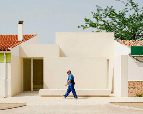 two white volumes outline minimal school expansion in rural spain