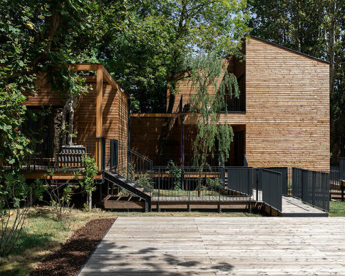 four wooden stilted structures host zero-emission resort's suites amongst centuries-old trees