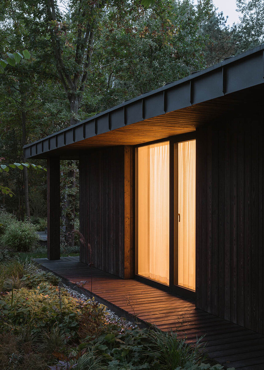 charred wood siding enfolds house near warsaw by kruk architekci