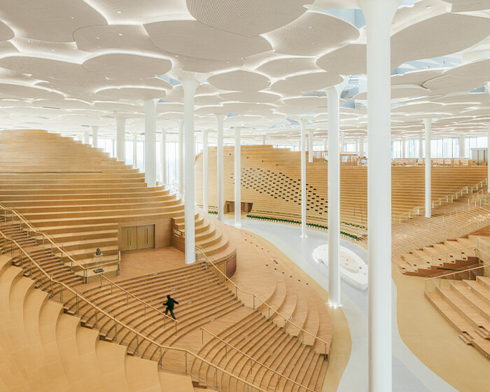 beijing city library by snøhetta opens to the public, revealing sculpted 'hills' and 'valleys'