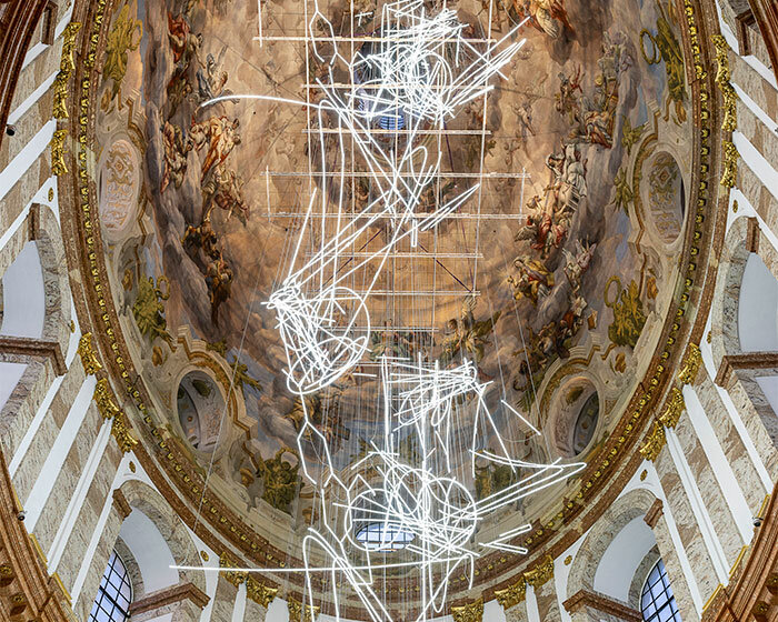 cerith wyn evans suspends neon squiggle installation within baroque church in vienna