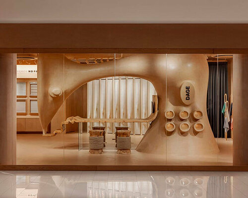 giant sewing machine sculpture takes center stage in dage curtain store by molos