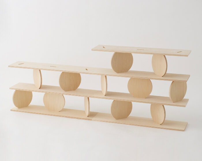 kengo kuma's modular wooden shelf with moving plates carries on ryuichi sakamoto’s design