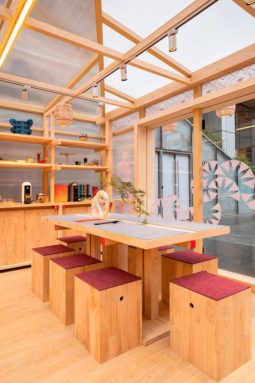 the interior space features modular wooden display props and movable furniture