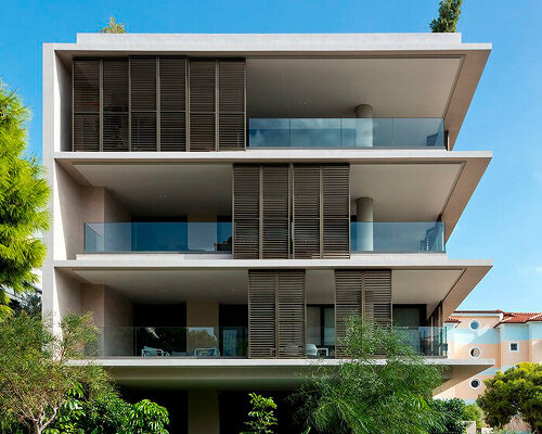 glass panes interlock between concrete slabs residential development in athens' suburbs