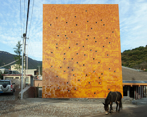 WAAAM museum's glazed yellow facade enlivens the beigou village in china