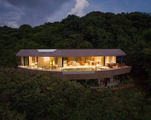 ansui house nosara by modus operandi aligns with its curvilinear site in costa rica