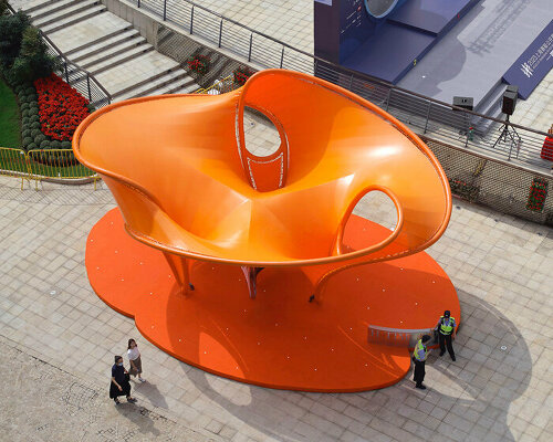 orange tensile membrane attaches to curved steel pipes shaping eddy pavilion in shanghai