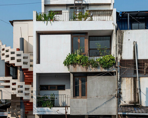 overlapping white volumes compose compact house by rahul pudale design in india