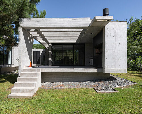 casa tres' exposed concrete volume by estudio galera floats above steep slope in argentina