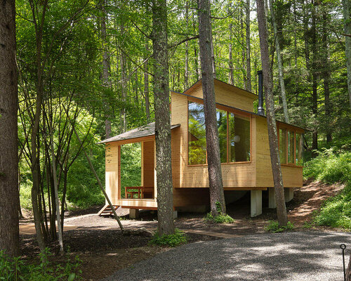 K+S architects' wooden forest hut is a terraced refuge in woods of japan