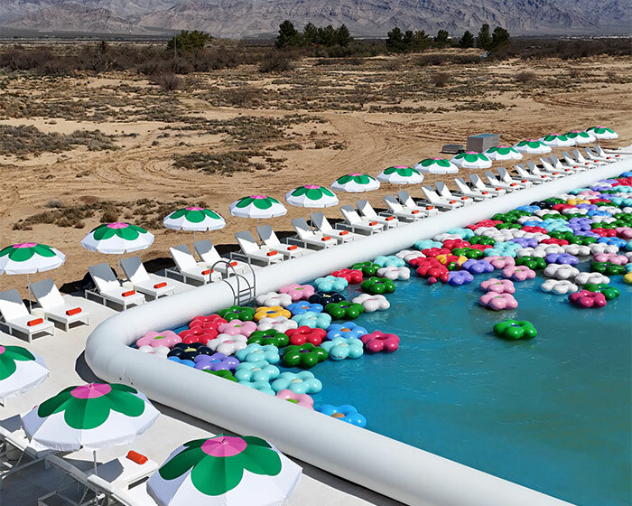 vibrant inflatable pool installation by CJ hendry pops up in the nevada desert