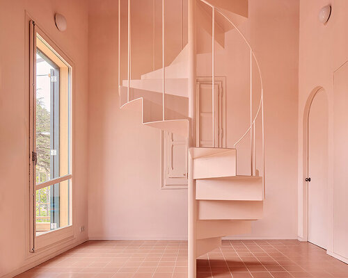 a light peach tone engulfs every corner inside this two-family house in barcelona