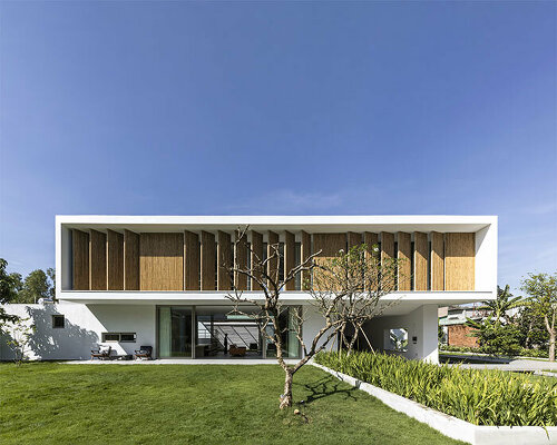 adjustable bamboo facade fronts verdant villa by KM architecture office in vietnam