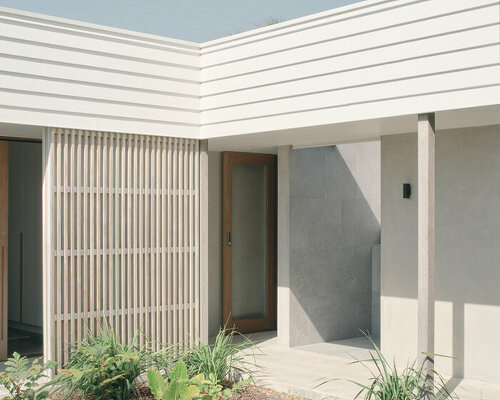 ribbed timber screens protect australian house from subtropical sun and rain