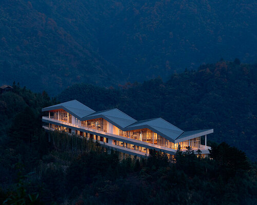 folded zinc roof undulates atop floating hotel by more architecture in china