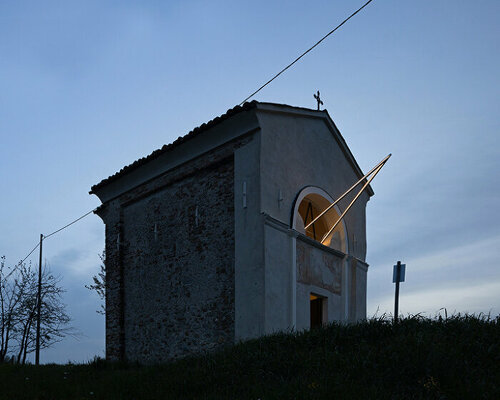 emilio ferro pierces chapel of san rocco with suspended beam of light in italy