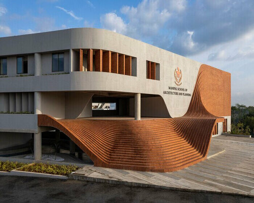 undulating steps clad in red terracotta bricks outline architecture school's entrance in india