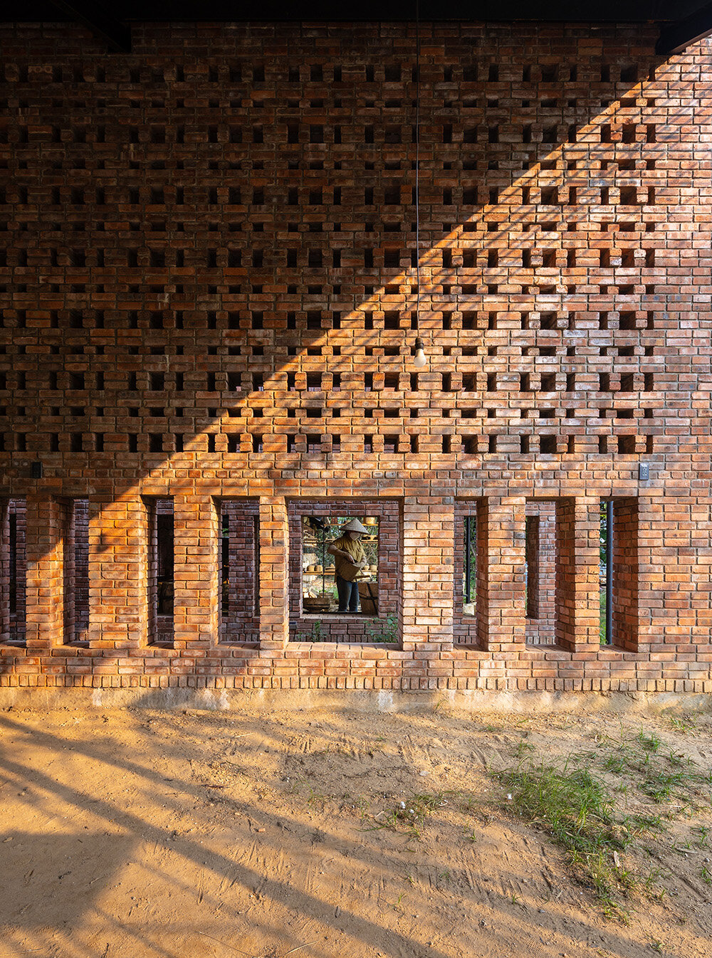 sweeping brick walls envelop tropical space's terra cotta workshop in ...