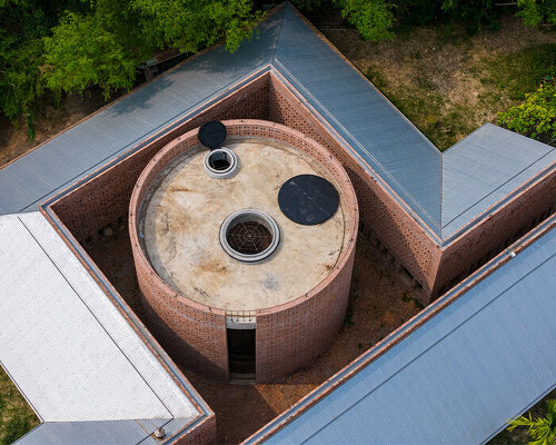 circular and folded brick walls envelop tropical space's terra cotta workshop in vietnam