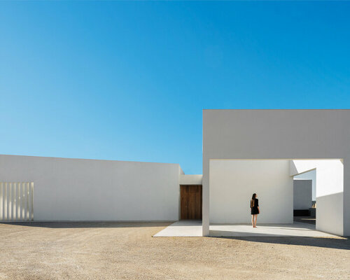 four solid white blocks outline wind house by ruben muedra arquitectura in spain