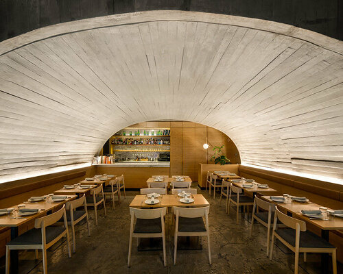 concrete arched vault shelters café-restaurant dining area in mexico city