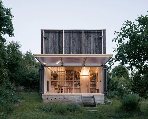 a folding, burnt-wood facade encloses BYRÓ architekti's garden pavilion