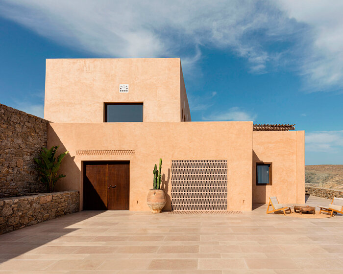 bobotis+bobotis plants terracotta-tiled coastal villa on mykonos' cliffside